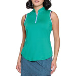 Woman wearing a green sleeveless top and blue patterned skirt on a white background